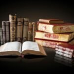 A collection of vintage books displayed elegantly on a reflective surface, ideal for education and literature themes.